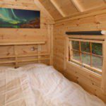 Slaapkamer met bed in een Finse Kota