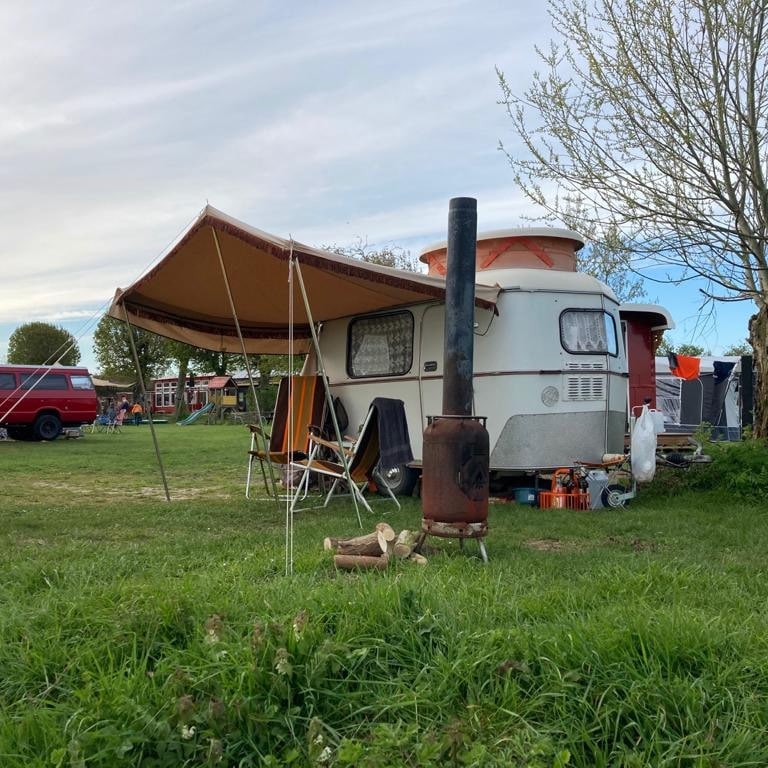 Retrocaravan met houtkachel op een camping in Gelderland