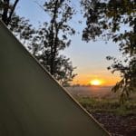 Zonsondergang van uit een tent op Landgoed Mariahoeve
